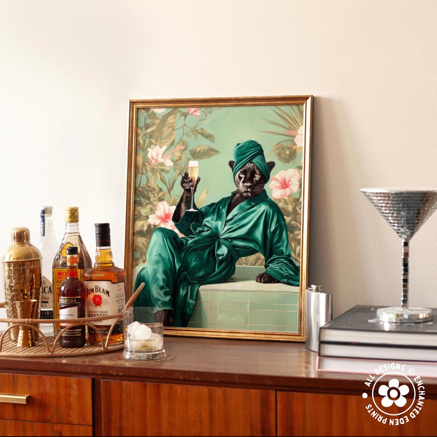 a framed painting of a person in a green robe and turban, holding a glass of wine and smiling. The painting is displayed on a wooden cabinet, surrounded by various bottles of alcohol and a cocktail shaker.