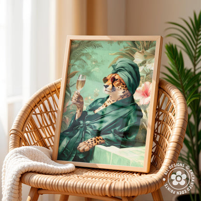 A framed print of a leopard wearing a green robe and holding a glass of wine, set against a tropical background.
