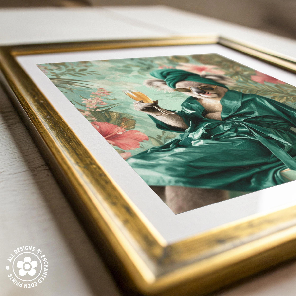 A framed print depicting a koala wearing a green robe and holding a yellow flower, set against a floral background.