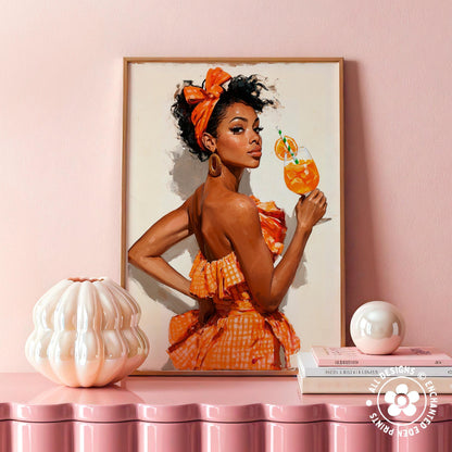 a framed painting of a woman in an orange dress holding a glass of orange juice, with a white vase and a stack of books on a pink shelf below the painting.