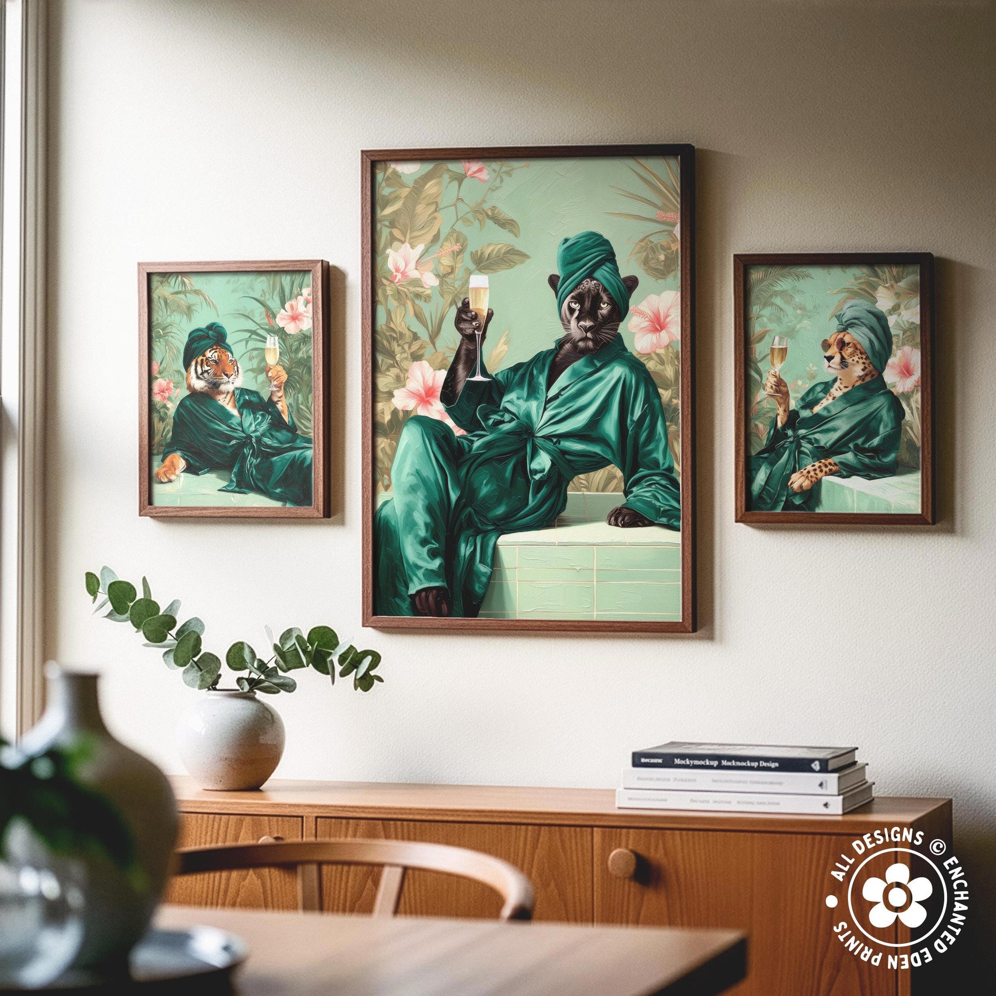 a wooden cabinet with a vase of greenery and a stack of books on top. Above the cabinet, there are three framed paintings depicting a person in a green robe and hat, holding a glass of wine and a book.