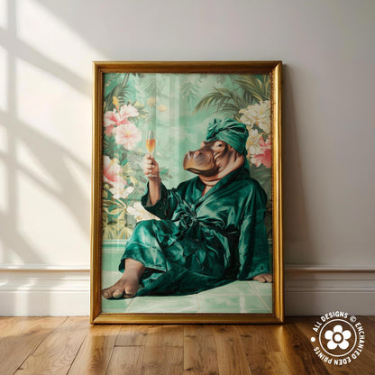 A framed painting depicting a hippopotamus wearing a green bathrobe and holding a glass of wine, with a tropical floral background.