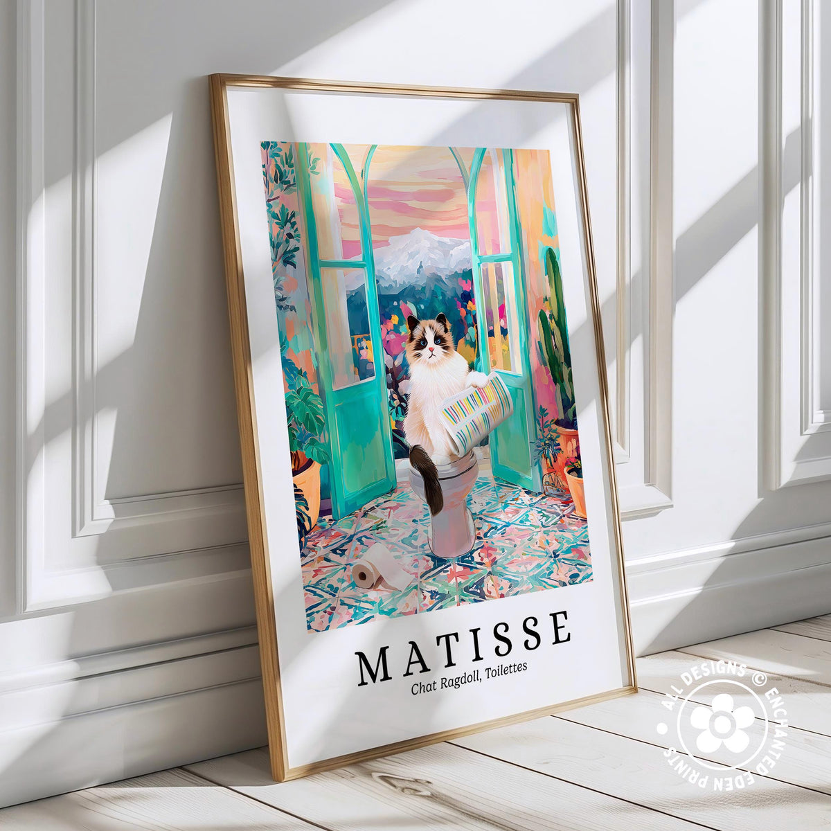 A framed poster depicting a cat sitting on a toilet in a colorful, whimsical setting, with a mountain landscape in the background.
