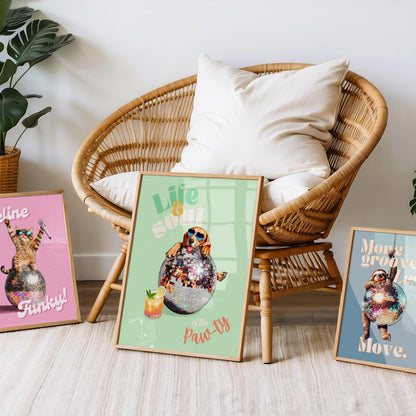 a wicker chair sitting next to three framed pictures