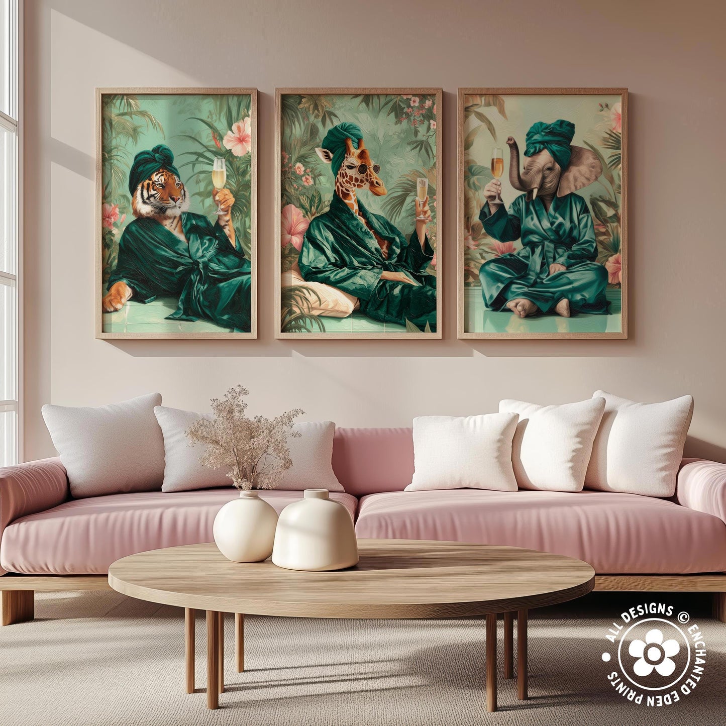 a living room with a pink sofa and a wooden coffee table. Above the sofa, there are three framed paintings depicting animals dressed in green robes, each holding a wine glass and a book.