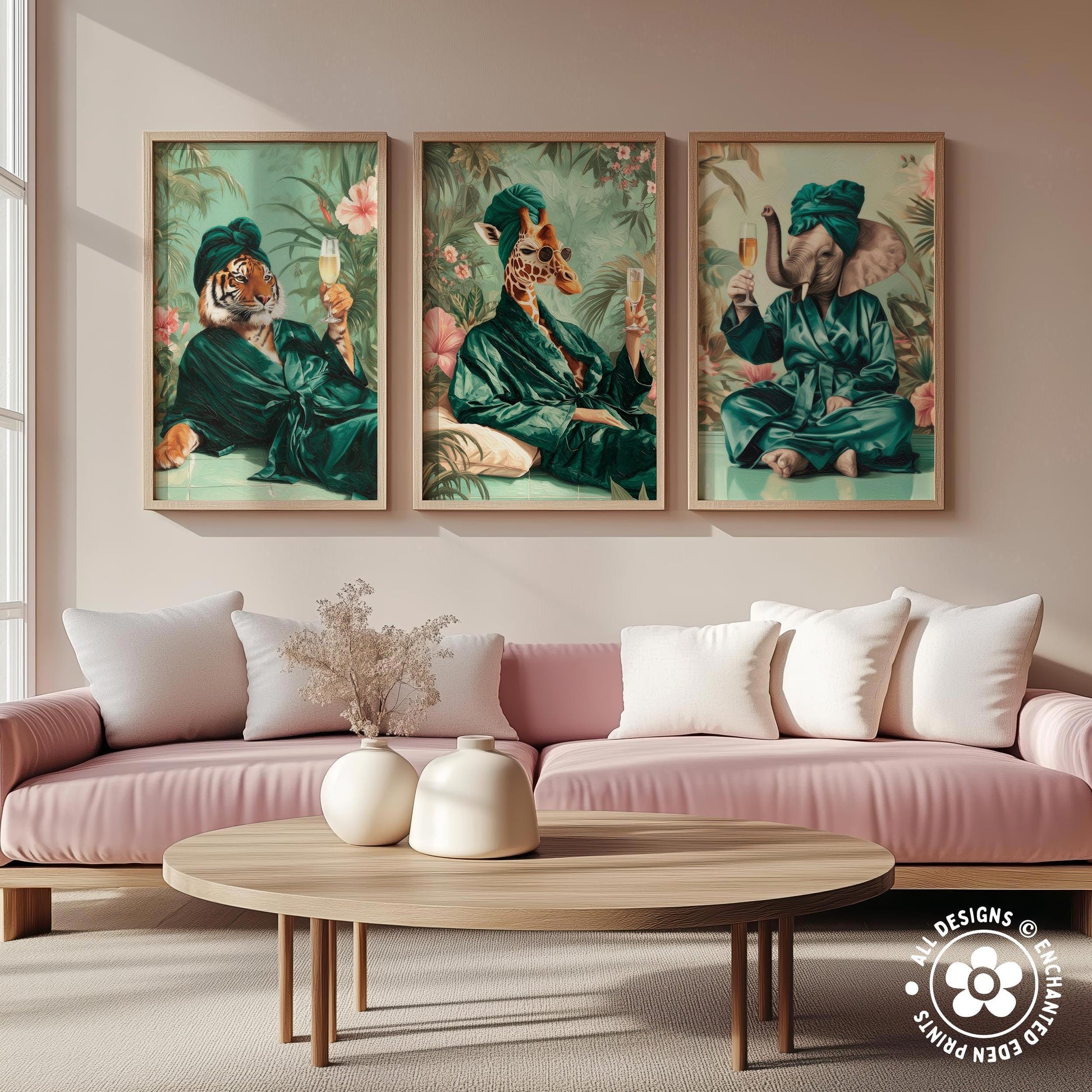 a living room with a pink sofa and a wooden coffee table. Above the sofa, there are three framed paintings depicting animals dressed in green robes, each holding a wine glass and a book.