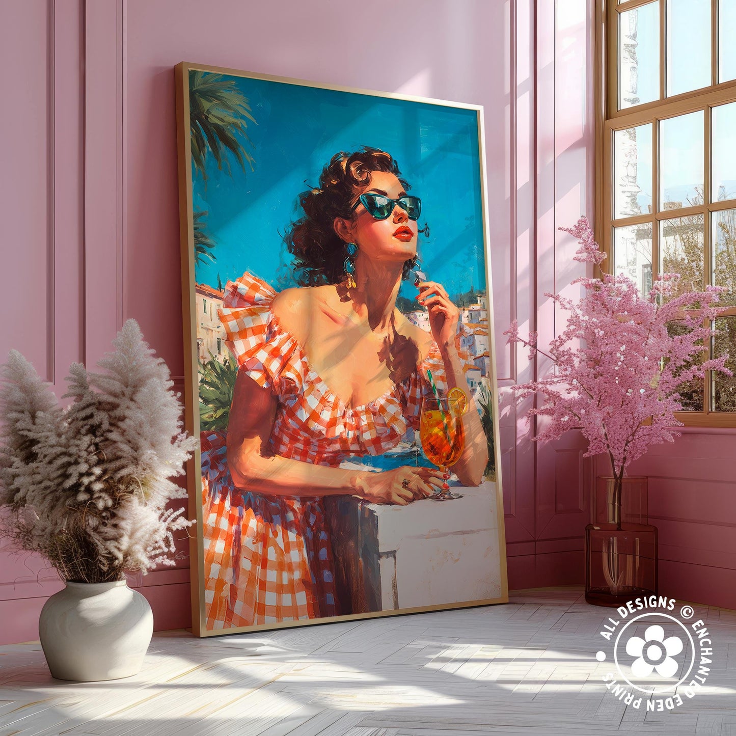 A large framed painting of a woman in a checkered dress, wearing sunglasses, is displayed on a pink wall. The painting is surrounded by pink flowers and a vase, creating a vibrant and cheerful atmosphere.