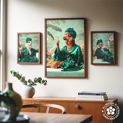 a collage of three framed artworks, each depicting a different animal in a green robe and holding a glass of wine. The artworks are hung on a wall above a wooden cabinet, which has a stack of books and a vase on it.