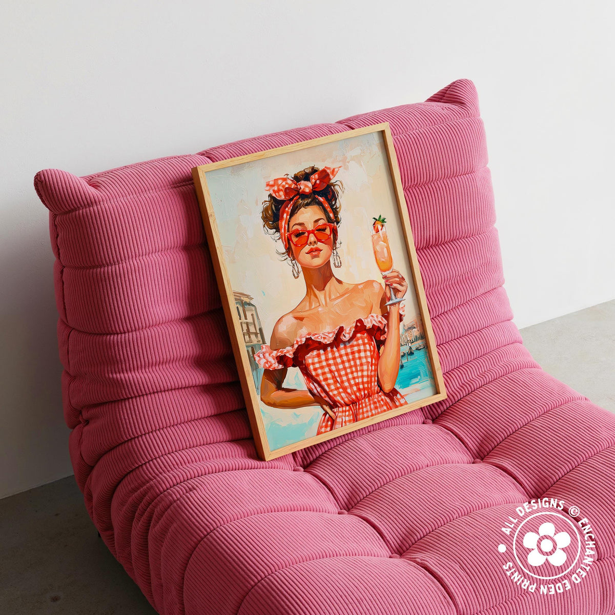 A framed painting of a woman in a red and white checkered dress holding a drink is displayed on a pink textured chair.