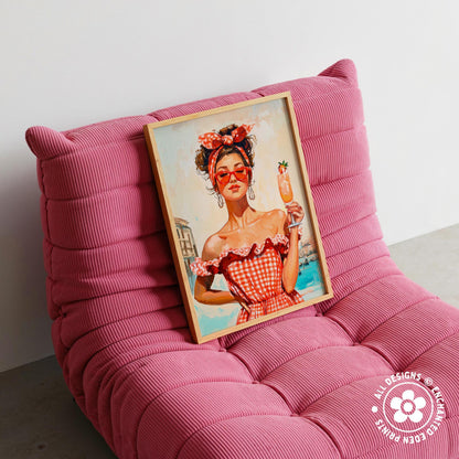 A framed painting of a woman in a red and white checkered dress holding a drink is displayed on a pink textured chair.