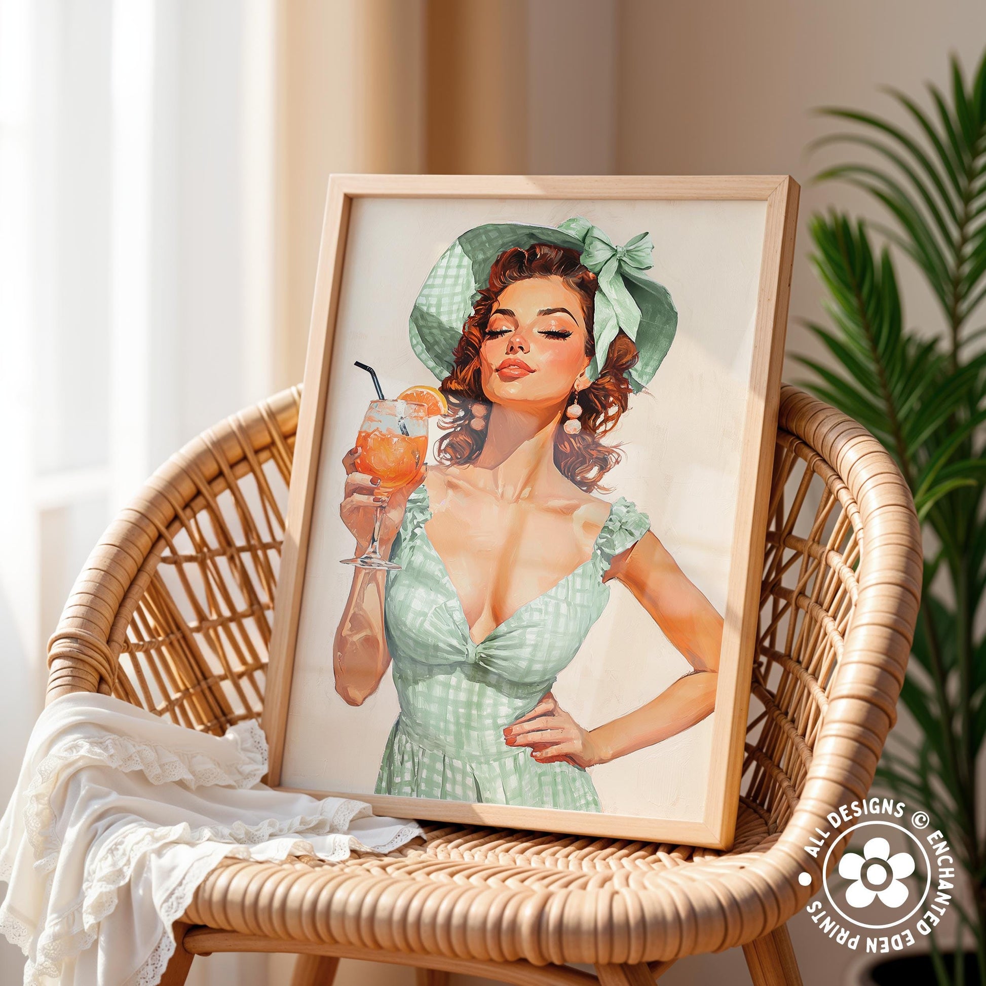 A framed illustration of a woman in a green dress holding a glass of what appears to be a cocktail, with a wicker chair and a plant in the background.