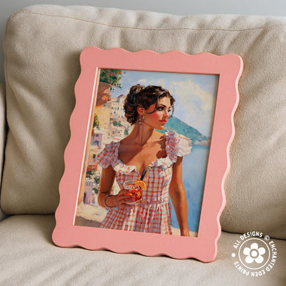 A pink framed painting of a woman in a checkered dress holding a drink, set against a backdrop of a scenic landscape.