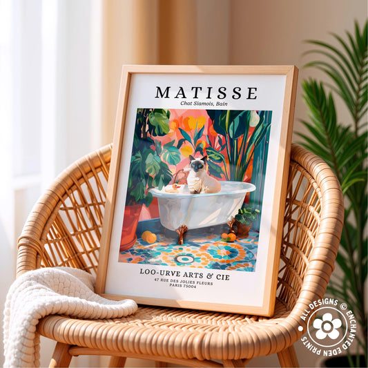 A framed poster of a cat sitting in a bathtub, surrounded by tropical plants, is displayed on a wicker chair.