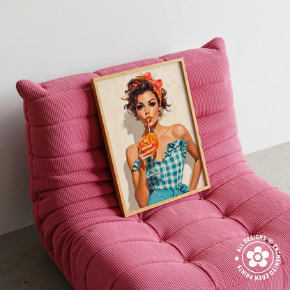 A framed illustration of a woman in a blue and white checkered dress holding an orange drink is displayed on a pink textured chair.