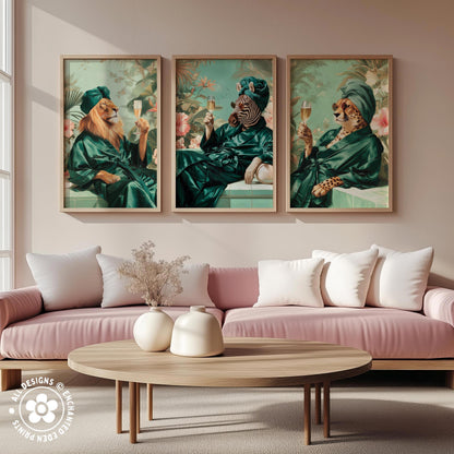 a living room with a pink sofa and a wooden coffee table. Above the sofa, there are three framed paintings depicting animals dressed in green robes, each holding a wine glass.