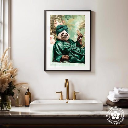 a framed painting of a panda wearing a green robe and turban, sitting on a bench and holding a book, hanging on a wall above a white sink with gold faucets.
