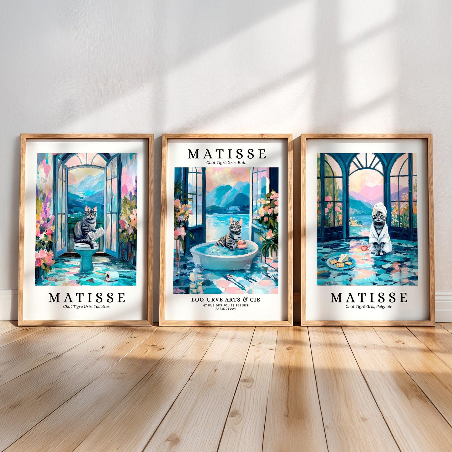 three framed artworks by the artist Matisse, each depicting a cat in a different setting. The artworks are arranged in a row on a wooden floor, creating a visually appealing display.