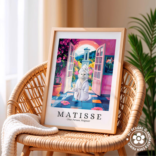 A framed illustration of a cat in a bathtub, surrounded by a colorful and whimsical scene, is displayed on a wicker chair.