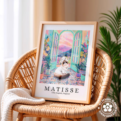 A framed painting of a cat sitting on a colorful rug, with a window and plants in the background, is displayed on a wicker chair.