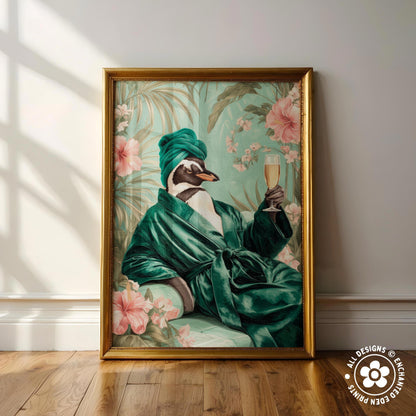 A framed painting depicting a penguin wearing a green robe and holding a glass of wine, surrounded by pink flowers and green foliage.