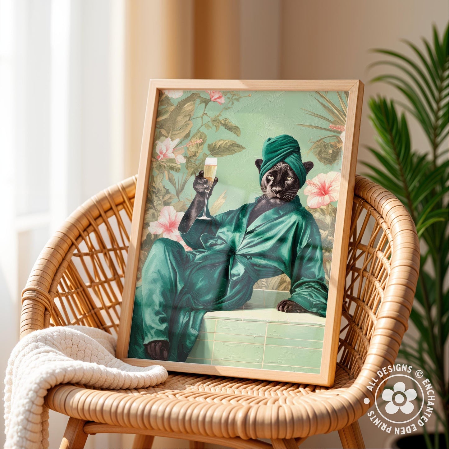 A framed illustration of a cat wearing a green robe and holding a glass of wine, sitting on a wicker chair.