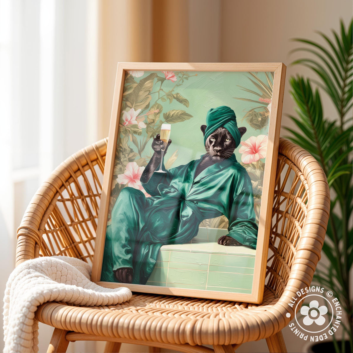 A framed illustration of a cat wearing a green robe and holding a glass of wine, sitting on a wicker chair.