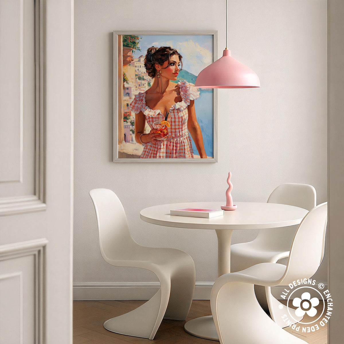 a dining area with a white table and chairs, a framed painting of a woman in a pink dress hanging on the wall, and a pink pendant lamp hanging above the table.