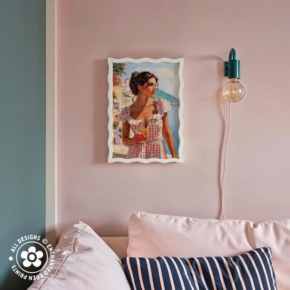 a framed painting of a woman in a red and white checkered dress, hanging on a pink wall above a couch with striped pillows.