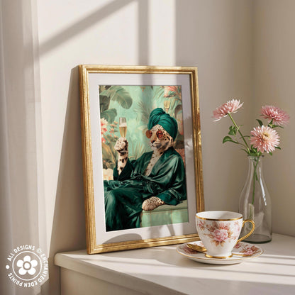 a framed painting of a leopard wearing a green robe and holding a glass of champagne, with pink flowers in a vase to the right.