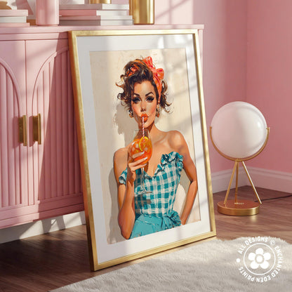 A framed illustration of a woman in a blue and white checkered dress holding a drink, with a pink cabinet and a lamp in the background.