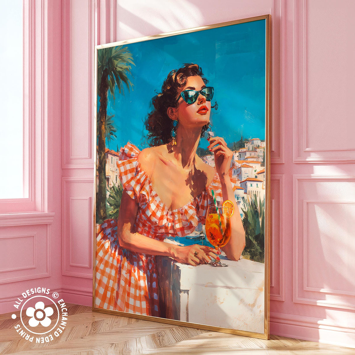 A large framed painting depicting a woman in a red and white checkered dress, wearing sunglasses and holding a drink, standing in front of a pink wall with palm trees and a building in the background.