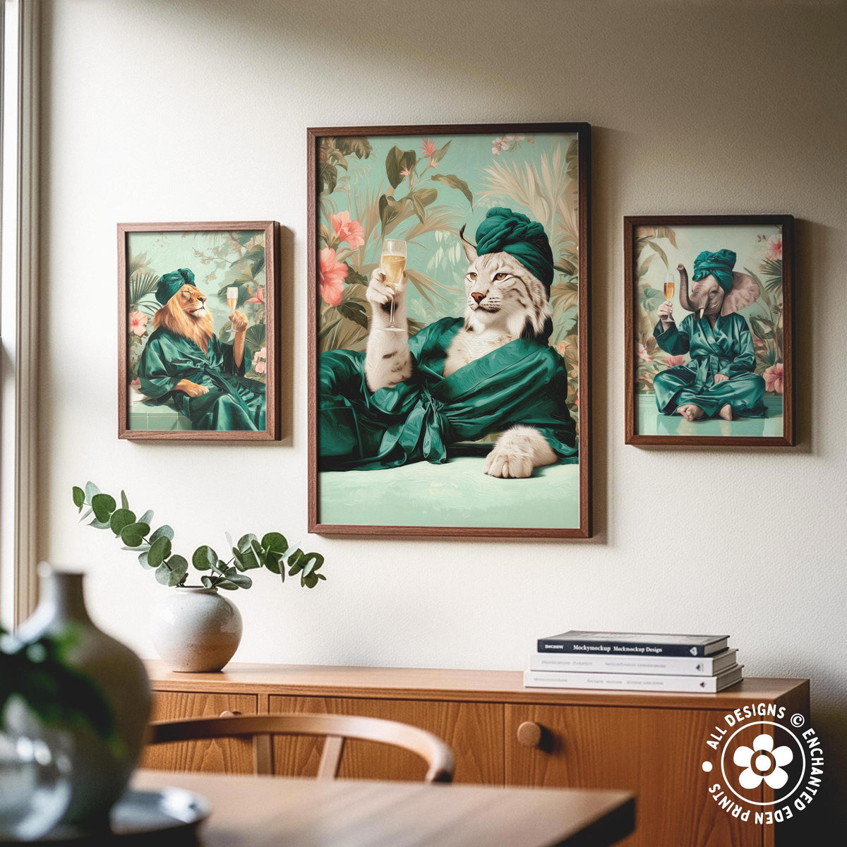 a collage of three framed pictures on a wall, depicting a cat dressed in a green robe and holding a glass of wine, a lion in a green robe holding a wine glass, and an elephant in a green robe holding a wine glass.