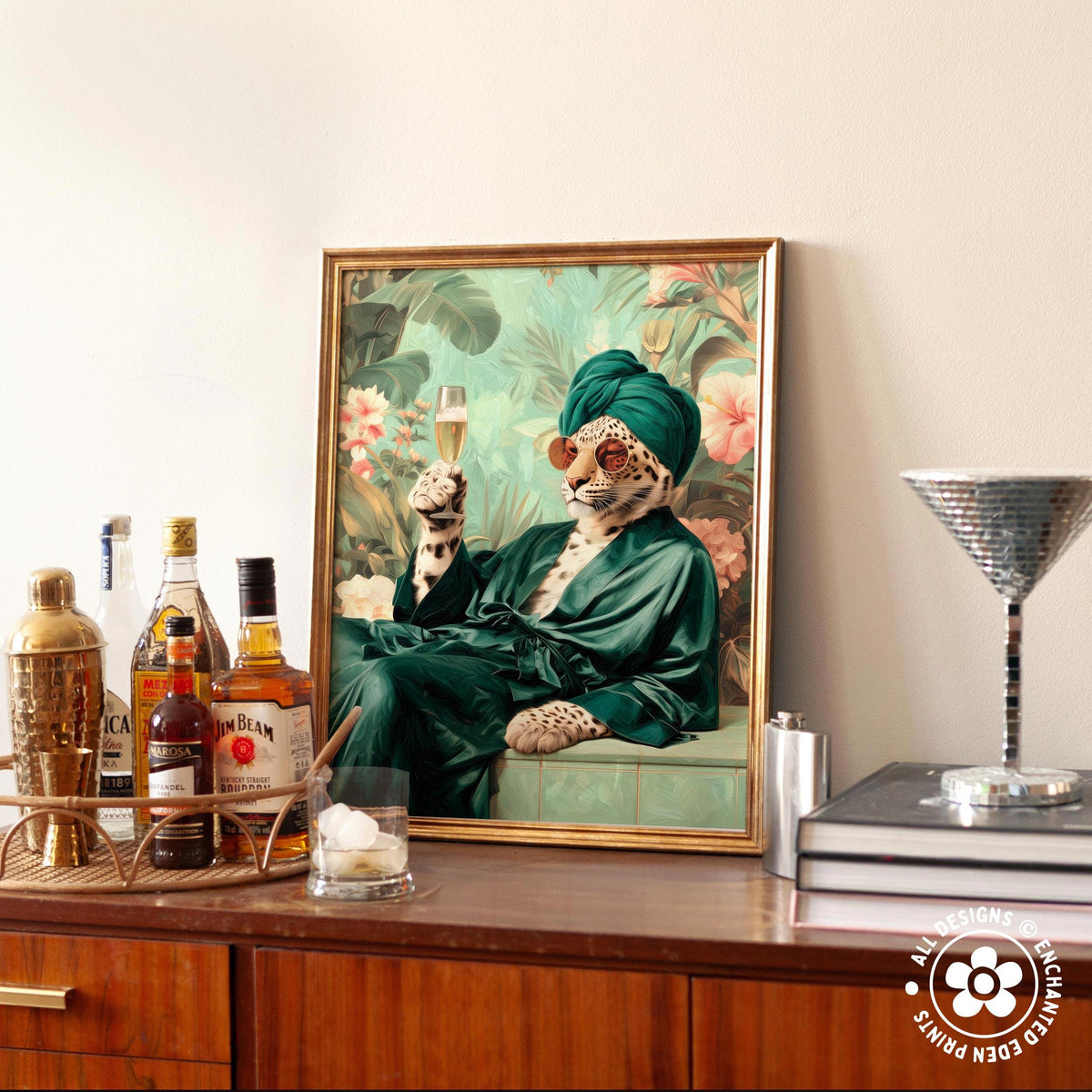 A framed painting of a leopard wearing a green robe and holding a glass of champagne, surrounded by various bottles of alcohol and a cocktail shaker on a wooden surface.