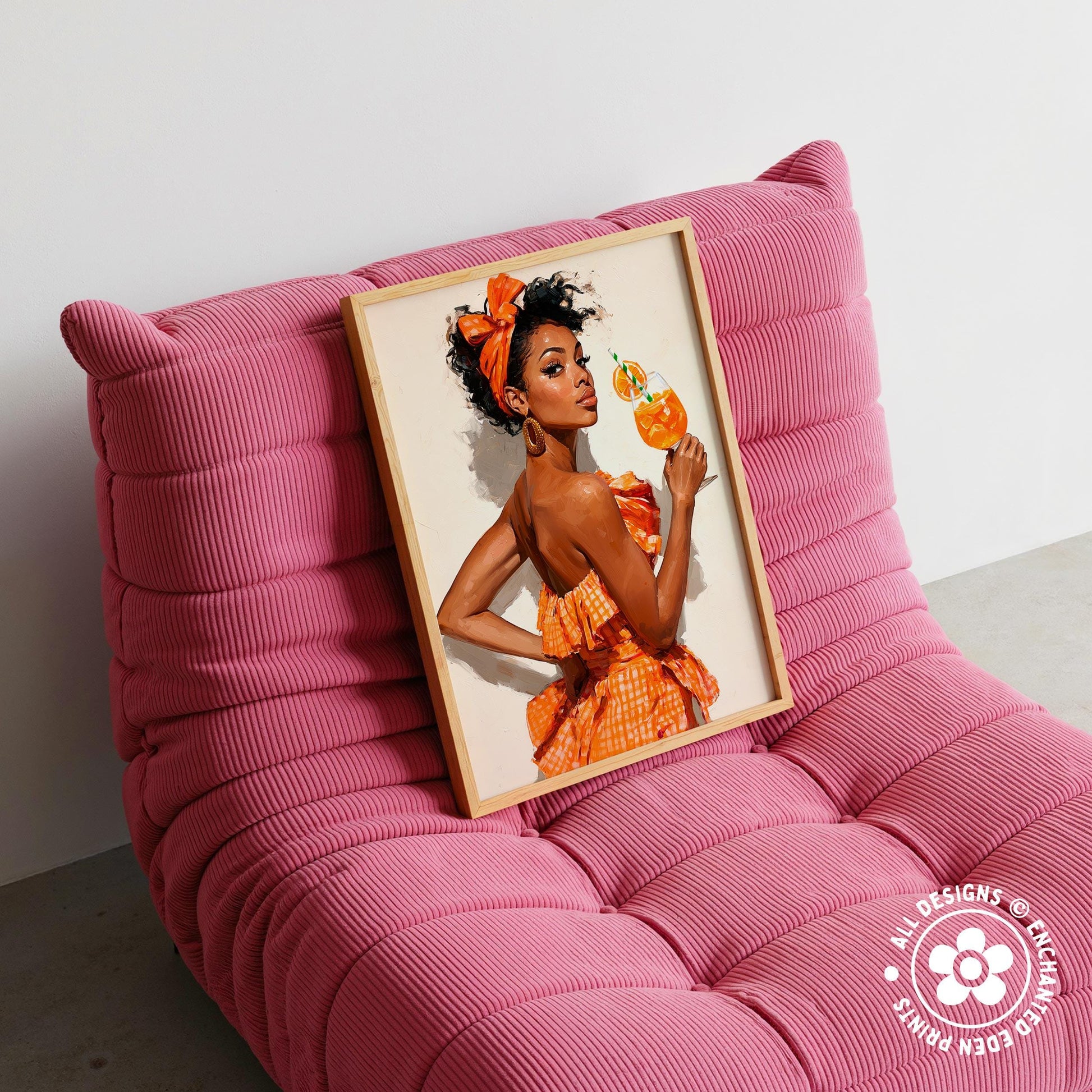A framed image of a woman in an orange dress is displayed on a pink couch.