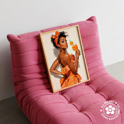 A framed image of a woman in an orange dress is displayed on a pink couch.